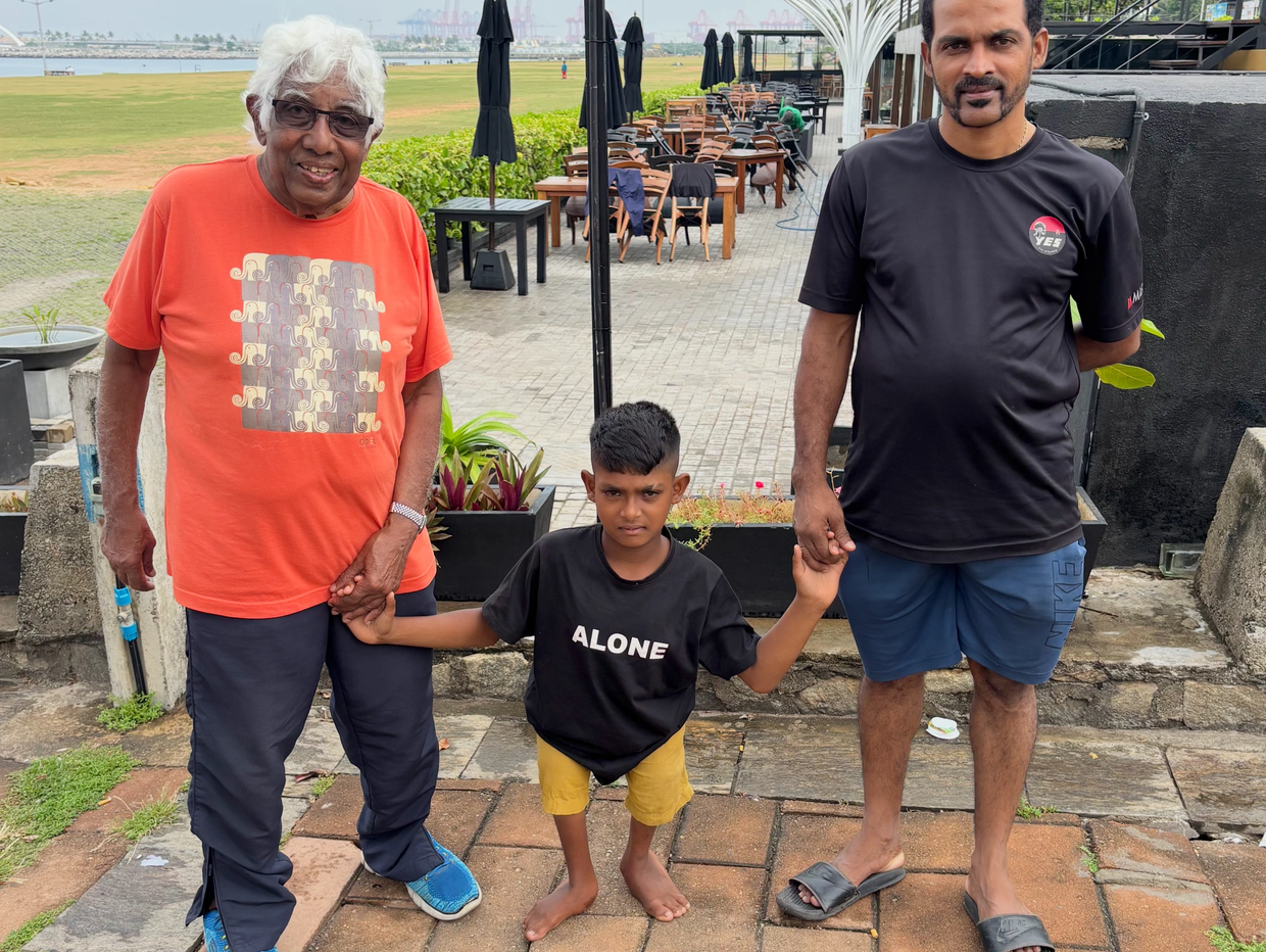 The author's father with Musali and his father at a seaside restaurant